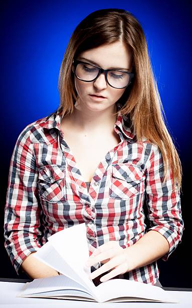 istock Calm young woman with nerd glasses learning diligently 178150961