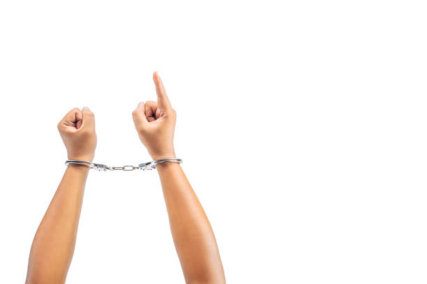 istock Human hand in handcuff with a hand gesture of pointing something 1781517247