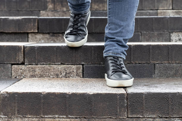 istock a man goes down the stone steps of an old staircase 1781528699