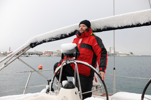 Steering a yacht in snowy weather, Croatia