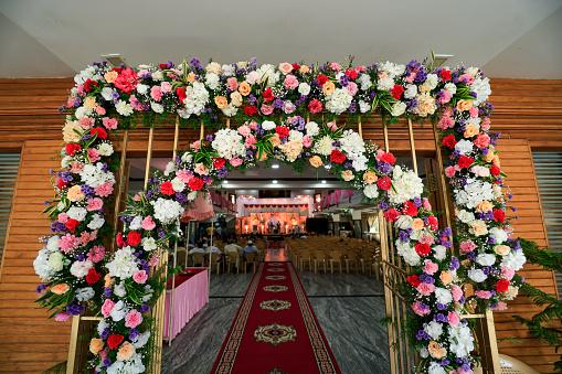 A stunning floral arrangement for the entrance of the marriage hall during the wedding day