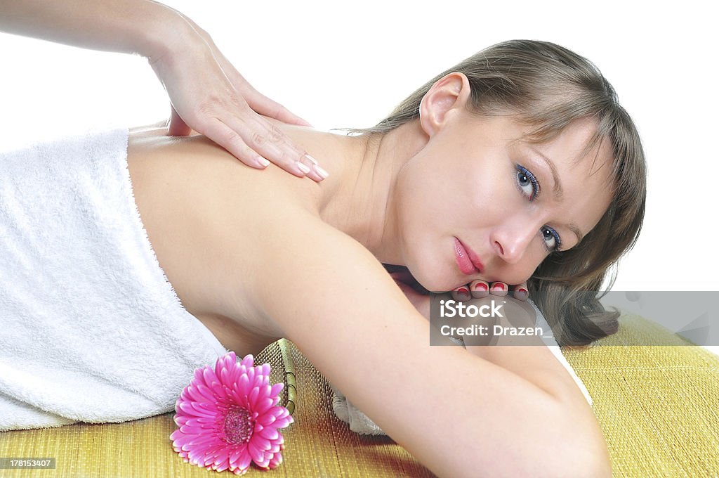 Beautiful caucasian female lying on massage table for back massage Caucasian woman on massage treatment 25-29 Years Stock Photo