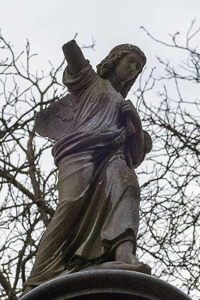 Weeping Angel in dilapidated Graveyard stock photo