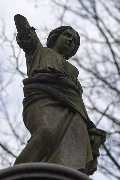 Weeping Angel in dilapidated Graveyard stock photo