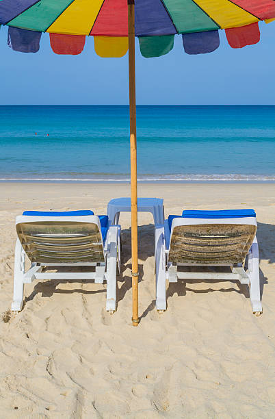 istock colourful umbrella and deck chairs on the beach 178156669