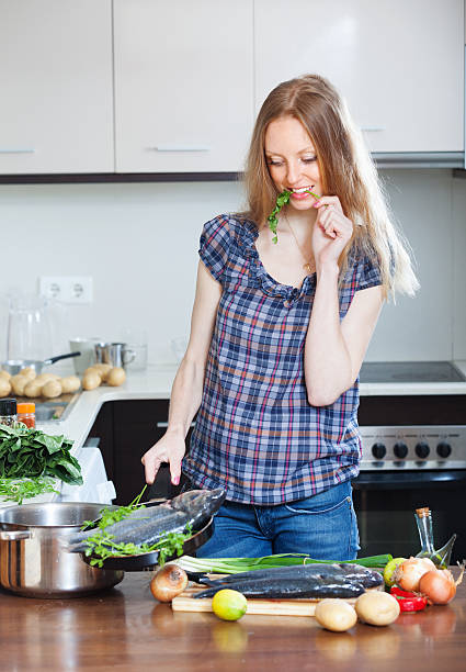istock woman cooking  fish in fryingpan 178158023