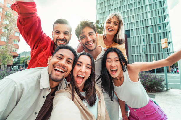 istock Multicultural friends taking selfie pic with cellphone outside - Happy young people having fun hanging out on city street - Summer vacation concept with guys and girls enjoying summertime holiday 1781586309