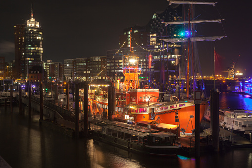 Hamburg, Germany - November 29, 2018: Night view of Hamburg port with illuminated ships and floating restaurants