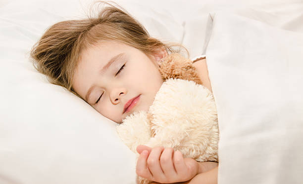 istock Adorable little girl sleeping in the bed 178159814