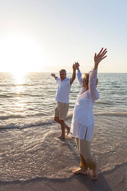 istock Happy Senior Couple Walking Holding Hands Tropical Beach 178160145
