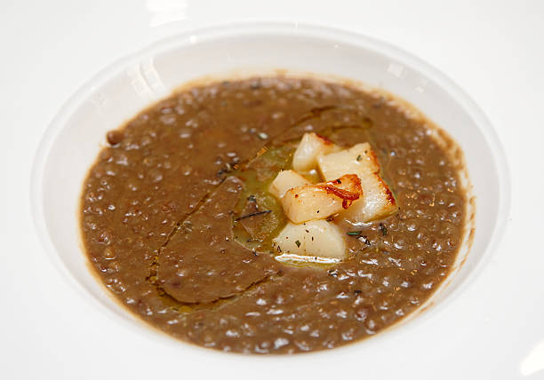 Lentil stew with scallops Lentil stew with scallops in plate - hearty but unpleasantly looking dish ugly soup stock pictures, royalty-free photos & images