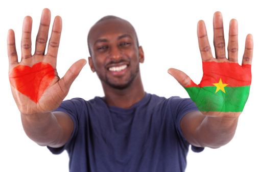 African man hands with a painted heart and burkinabe flag, i love burkina faso concept, isolated on white background