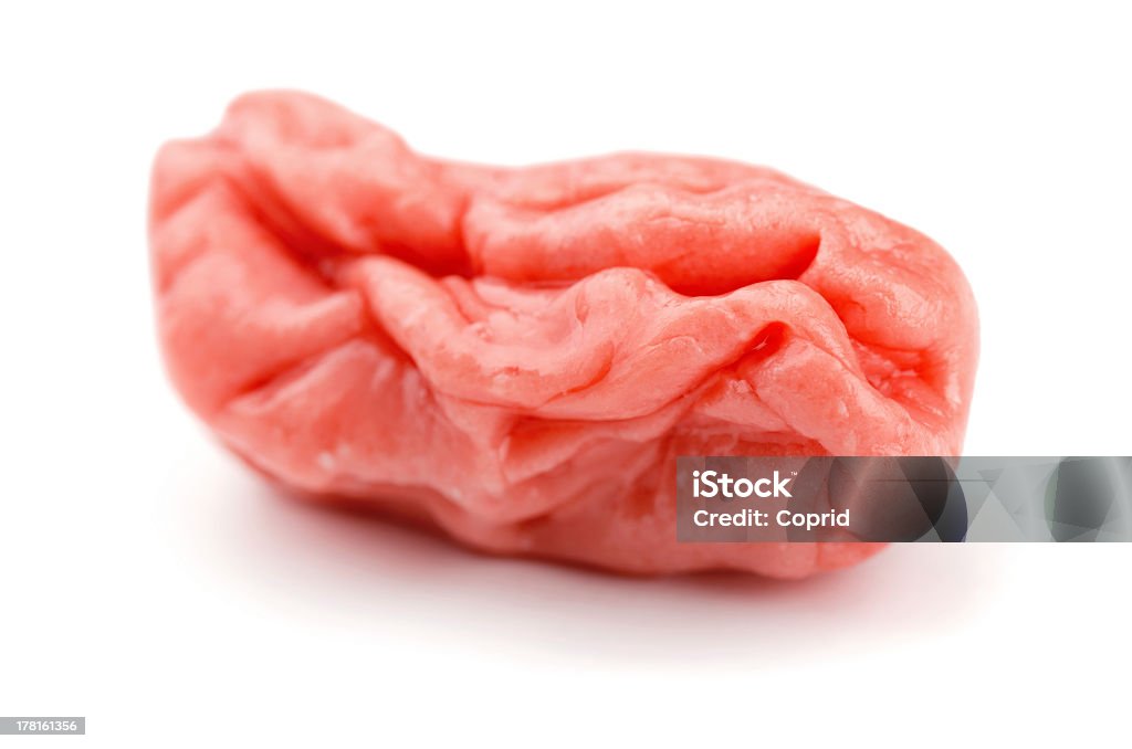 Chewed up gum in white background Piece of pink chewed bubble gum isolated on white Bubble Gum Stock Photo