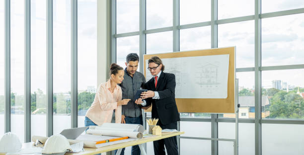 istock Engineer team is meeting to inspect the construction blueprint drawings, work plan and distribute work before starting the building 1781618972