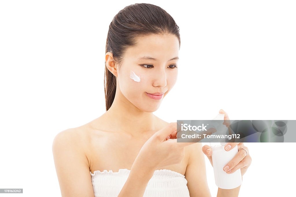 beautiful face of woman applying moisturize cream young beautiful face of woman applying moisturize cream Adult Stock Photo