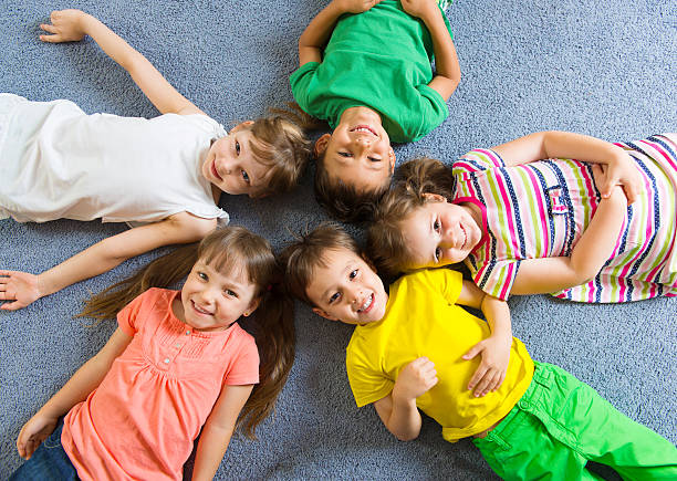 istock Cute little children lying on floor 178163830