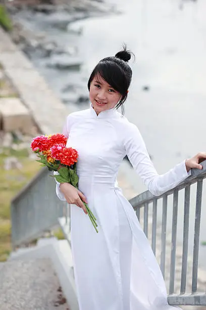 Vietnamese young girl in white traditional dress aodai (ao dai)