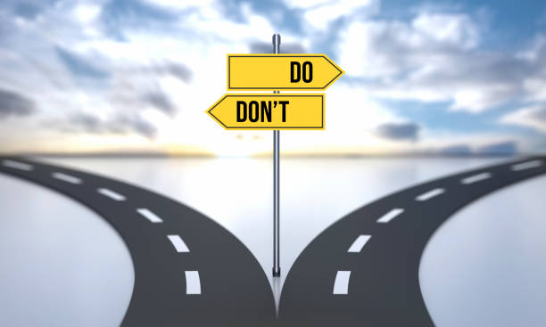 do or don't. divided road and decisions with road sign - success failure dreams road sign imagens e fotografias de stock