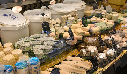 Paris, France. June 30 2022. At the beautiful local market Marchè Popincourt, at a cheese counter with all the French specialties.