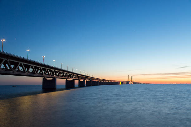 The Oresund bridge The bridge connects Denmark and Sweden and is the longest road and rail bridge in EuropeThe Oresund Bridge also connects two major metropolitan areas: those of the Danish capital city of Copenhagen and the major Swedish city of Malmö. Total length of just over 10 miles! oresund bridge stock pictures, royalty-free photos & images