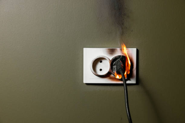 istock burning wall electrical socket with plugged appliance cable from short circuit in house. concept of fire safety and power overload at home 1781675138