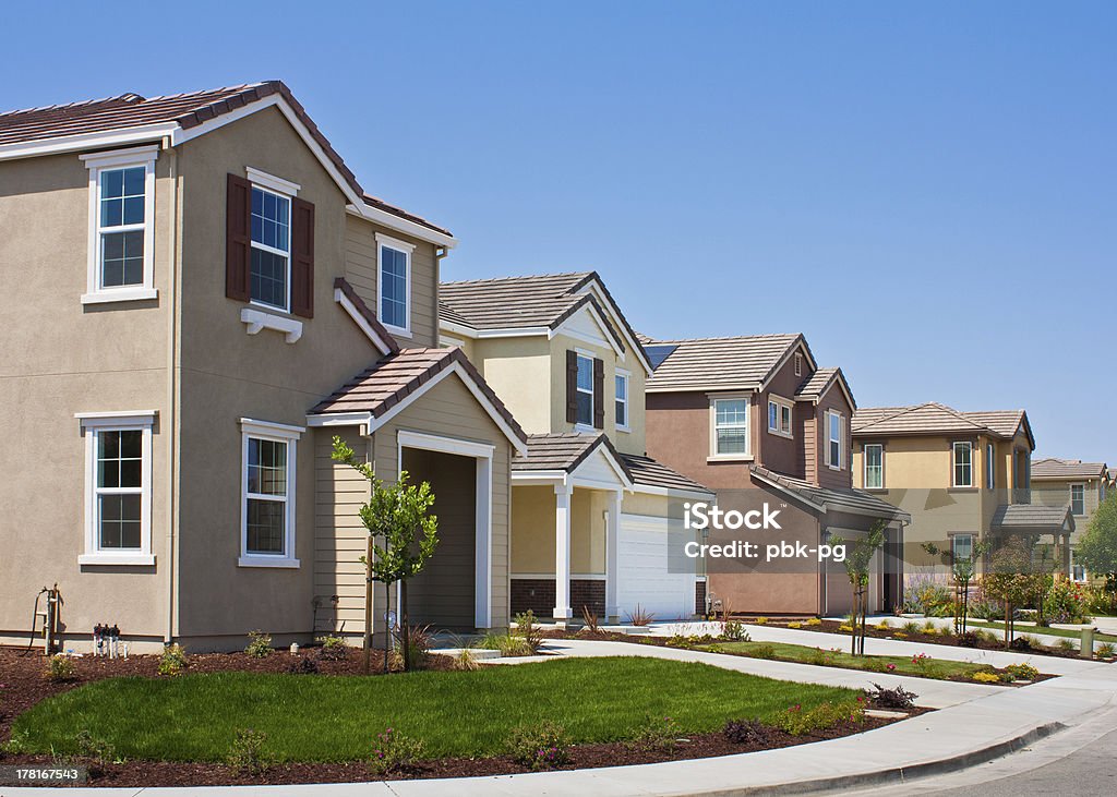 A street side view of four tract houses in a row A row of new tract houses in a residential subdivision in Morgan Hill, California. California Stock Photo