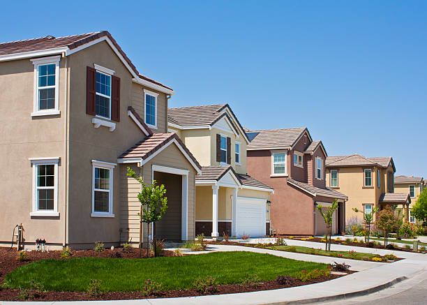 A street side view of four tract houses in a row A row of new tract houses in a residential subdivision in Morgan Hill, California. generic description stock pictures, royalty-free photos & images