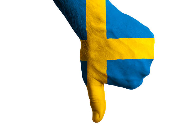 Hand with thumb down gesture in colored sweden national flag as symbol of negative political, cultural, social management of country
