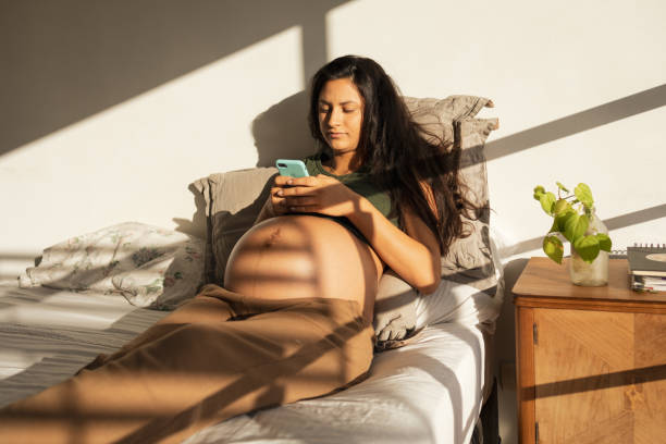 istock Pregnant woman using mobile phone at the bedroom. 1781683763