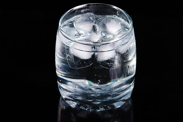 Glass of water with ice stock photo