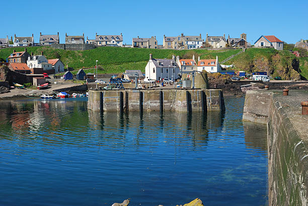 the main harbour, boats, and village at St. Abbs, Berwickshire stock photo