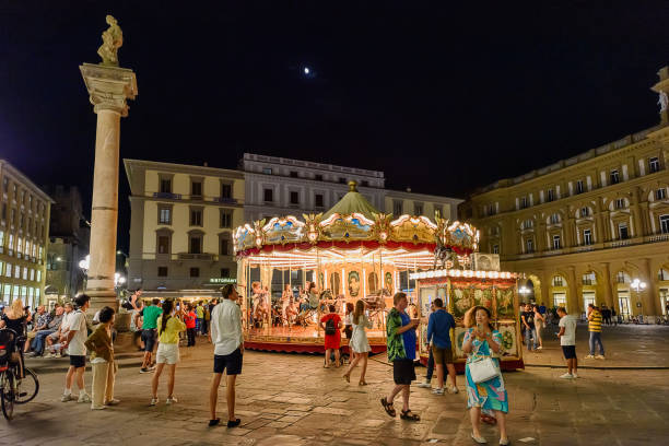Florence, Italy - January 20, 2025: Night view of Piazza della Repubblica in Florence, Tuscany, Italy, showing the illuminated Arcone and the classic carousel. The lively historic Florentine piazza was rebuilt during the 19th century.