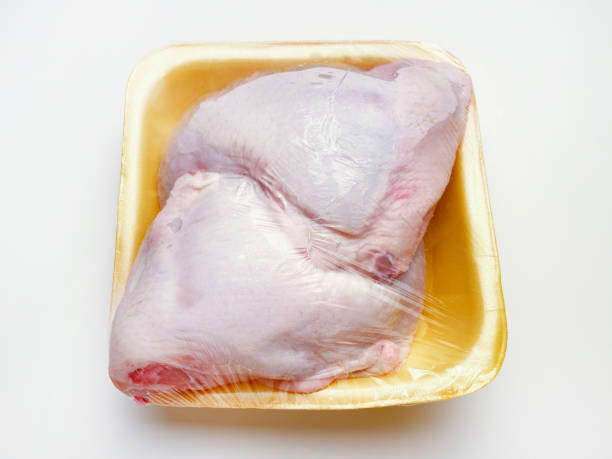 istock Package of raw chicken legs on white background 1781702750