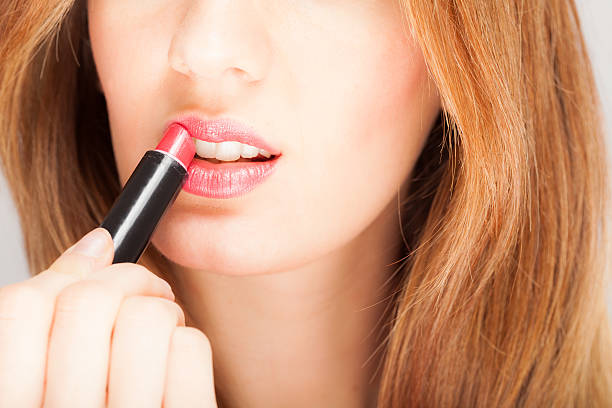 istock Woman applying lipstick 178170491
