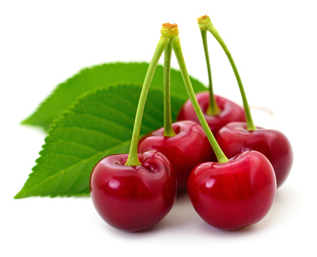 Sweet cherries with stem and leaves on white background.