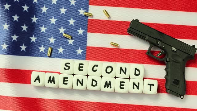 Gun on American flag and word second amendment