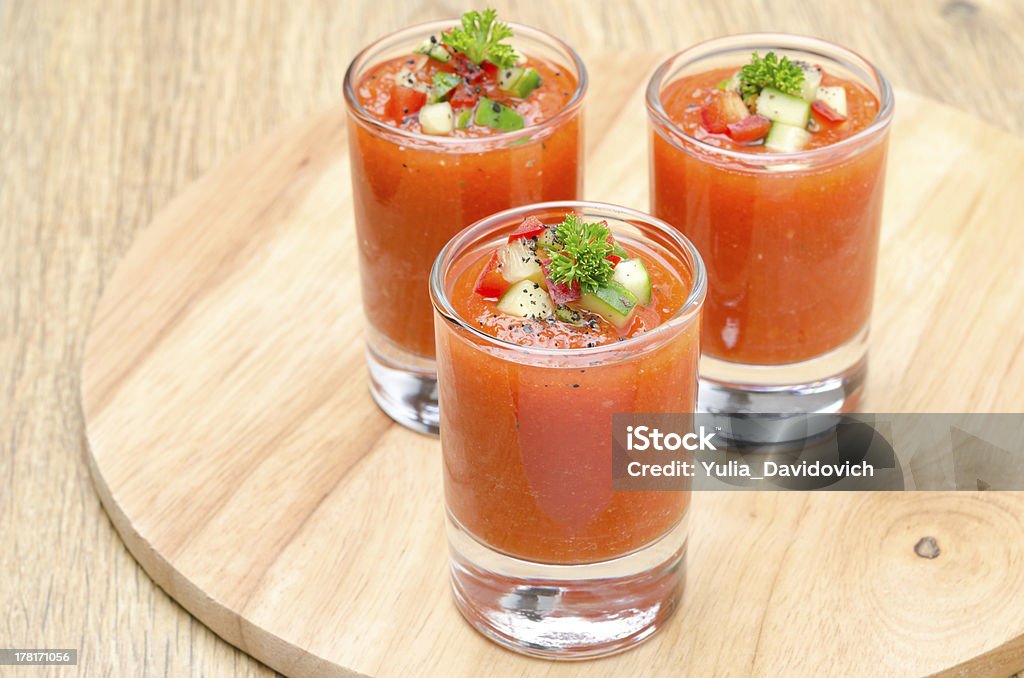 cold tomato soup gazpacho in portion glasses, horizontal cold tomato soup gazpacho in portion glasses on a wooden board, horizontal Appetizer Stock Photo