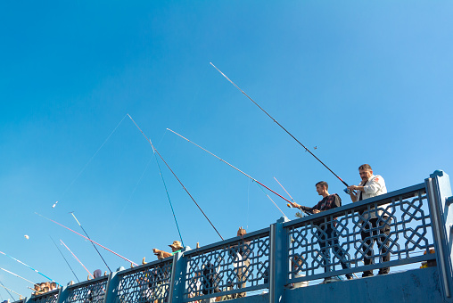 Istanbul, Turkey, 15th of October 2023, Turkish people fishing on Galata bridge of Istanbul,