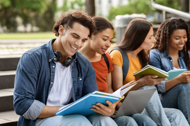 istock Group of students preparing for exams together outdoors, using laptop and workbooks 1781711726