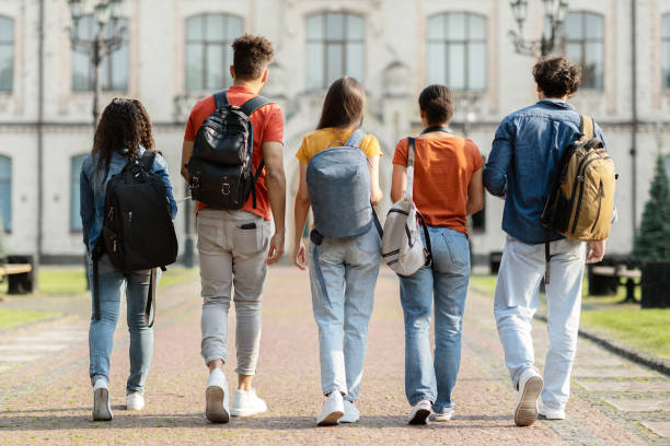 istock Group of five students with backpacks walking at university campus together 1781711735