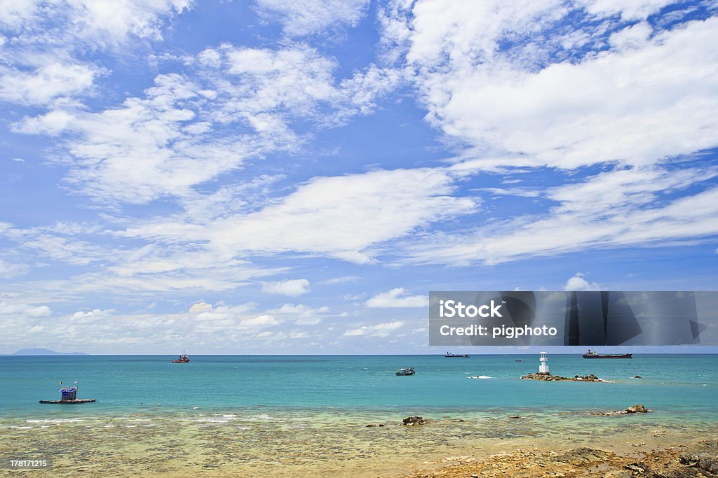 Farol entre o mar e céu azul - Foto de stock de Azul royalty-free