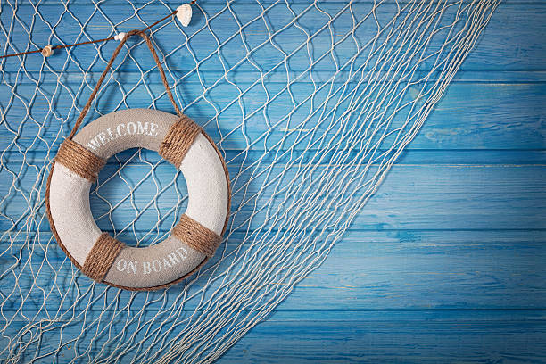 Life buoy and netting on blue background Life buoy decoration on blue shabby background aboard stock pictures, royalty-free photos & images