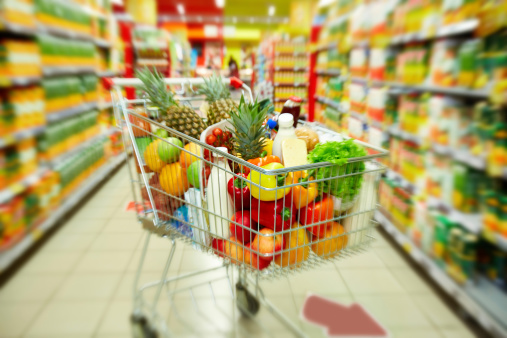 Image of cart full of products in supermarket