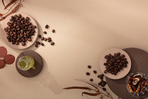 Brown background with minimal props and coffee beans decorated, form an empty space for display product and design. Concept for advertising organic product for body care and hair care