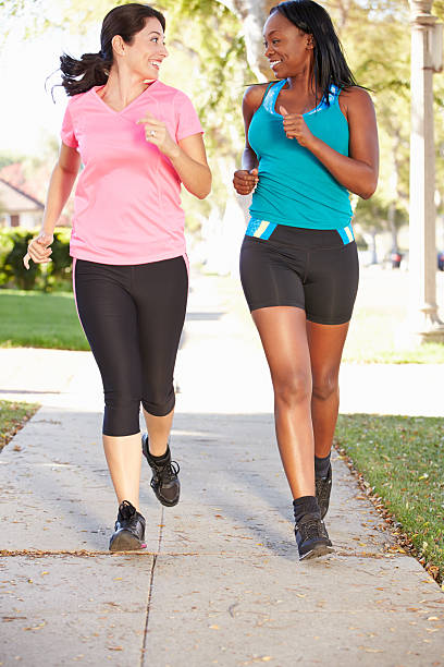 istock Two Female Runners Exercising On Suburban Street 178172106