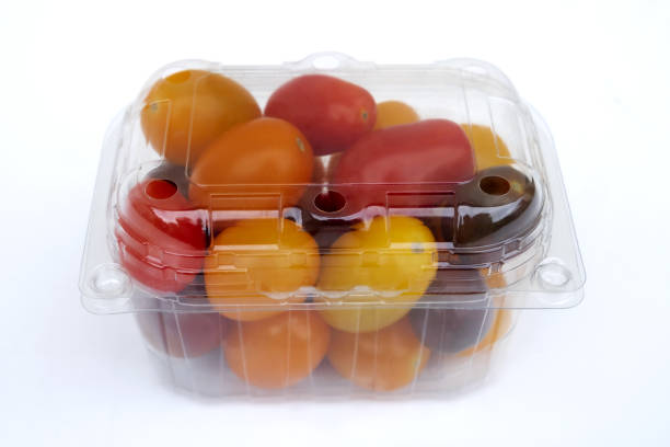 Tomatoes vegetable in plastic wrap - concept of plastic overuse and pollution