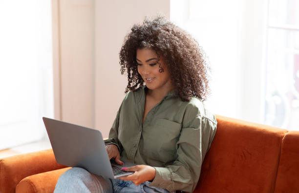 istock Smiling Black Bushy Woman Working On Laptop Computer A Home 1781725624