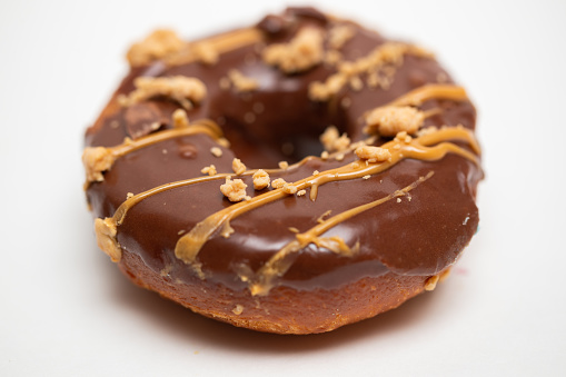 Peanut butter chocolate donut on white background