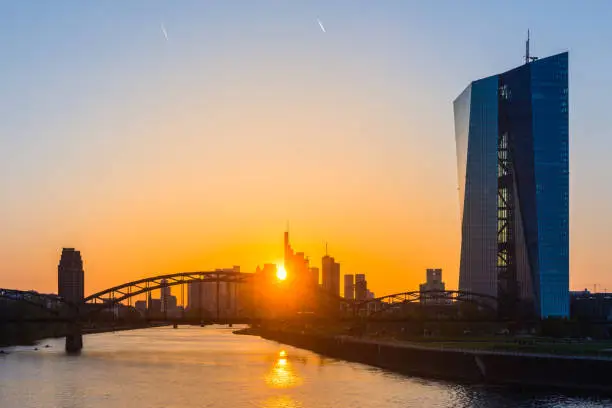 Photo of Frankfurt golden sunset over silhouetted skyscrapers River Main ECB Germany