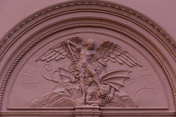 skulptur von saint michael slaying the dragon - st michaels church stock-fotos und bilder